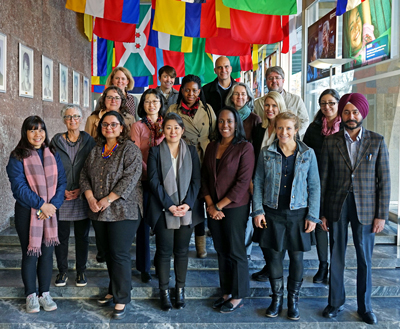 Participants of EIO 2019 standing on steps at the WHO, looking at the camera and smiling
