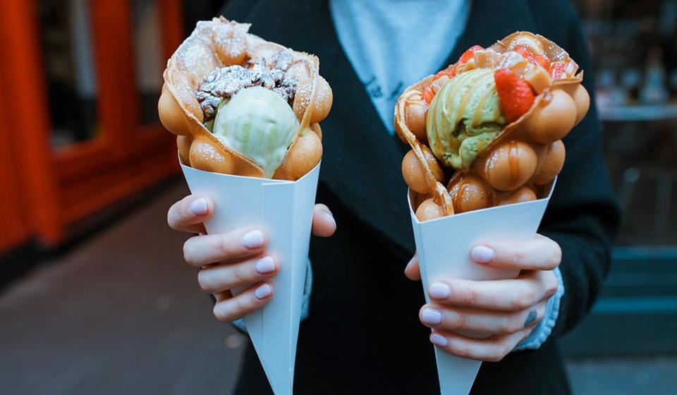 Hands holding two ice cream cones