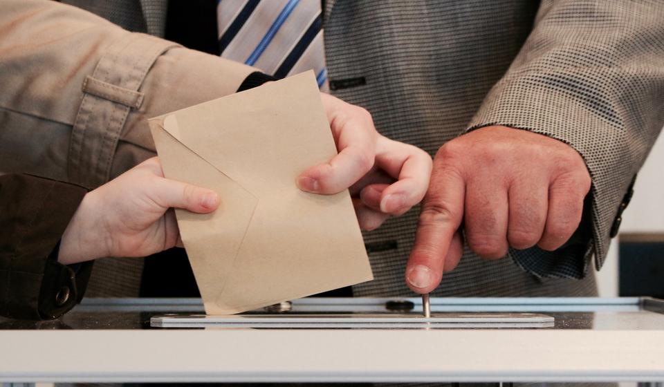 Envelope being placed into a ballot box
